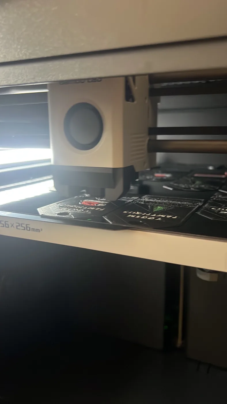 Close-up of a 3D printer print bed with a finished part